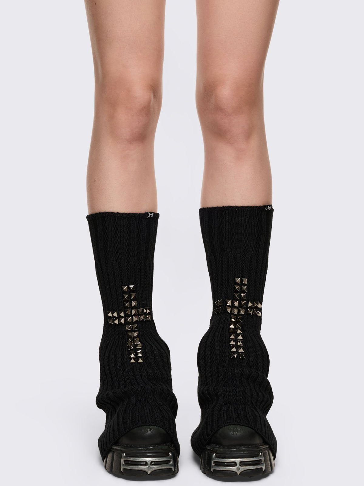 Black knitted flare leg warmers with silver studded cross design.