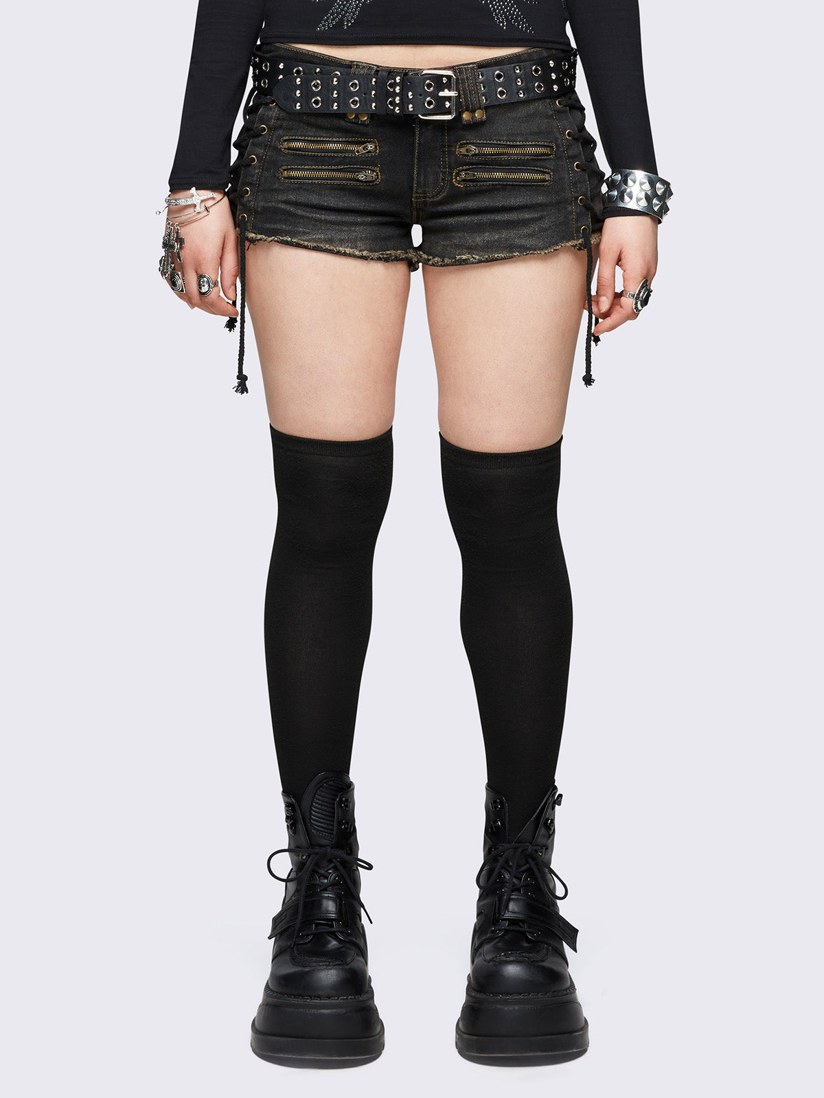 Black washed denim hot pants shorts featuring adjustable lace-up sides and double zip front details.