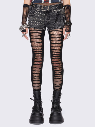 Black slashed cut-out tights with fishnet layer underneath.