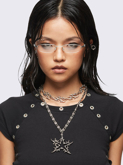 Set of 2 silver necklaces: A chunky chain with multiple sigilism charms and other with a star pendant.