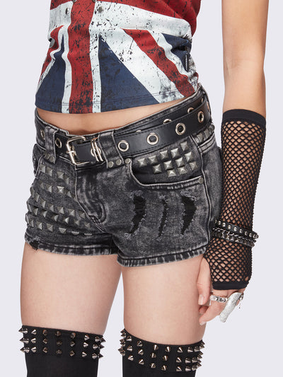 Black washed denim hot pants. Shorts with metal stud embellishments and distressed details. Grunge punk aesthetic.
