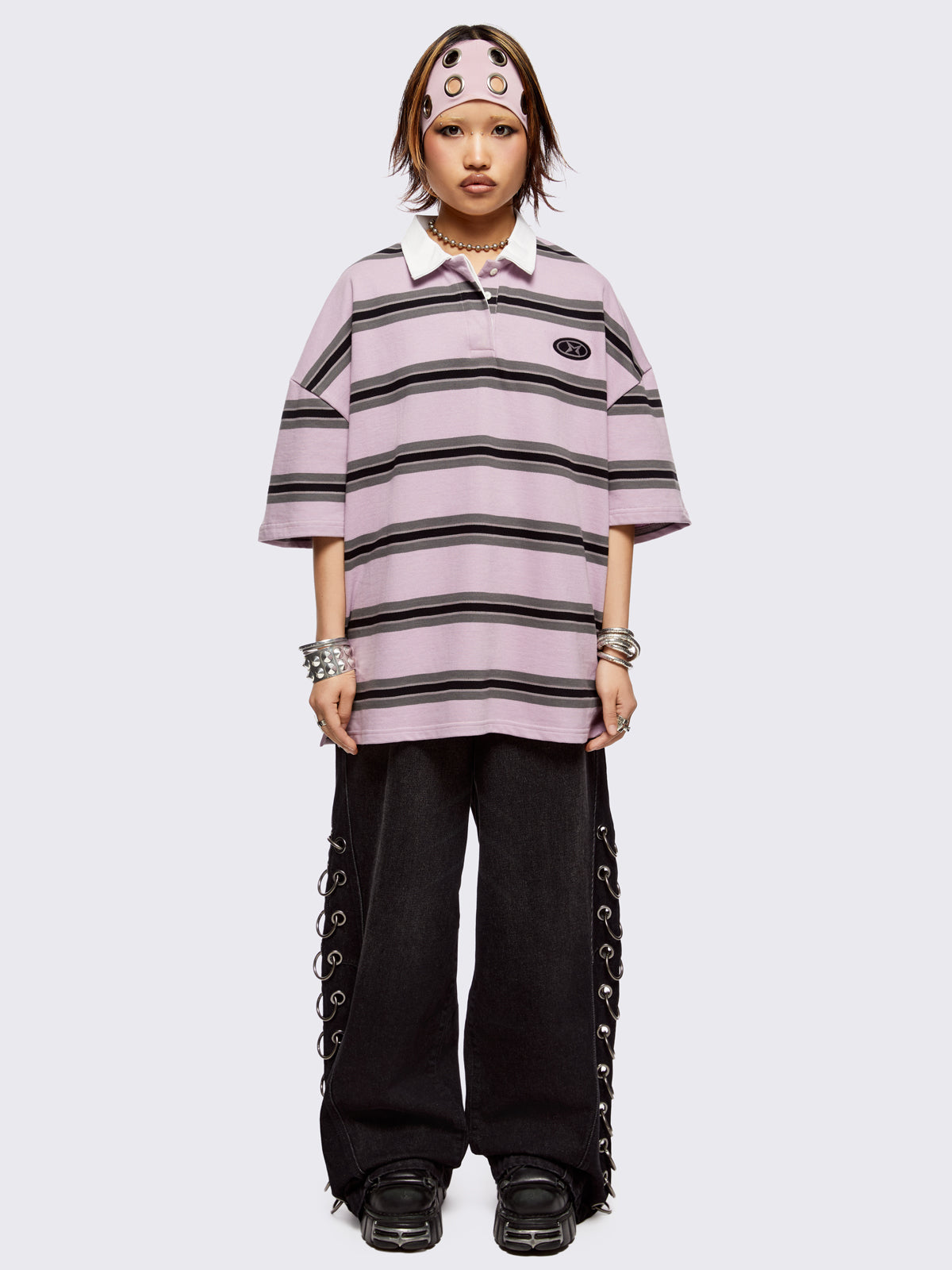 Pink rugby polo with black and grey stripes, white spread collar and a oversized fit.