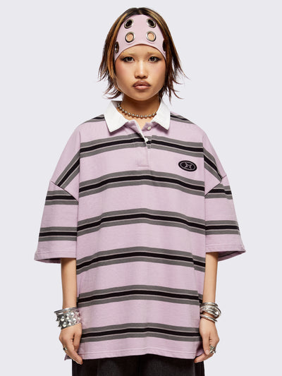 Pink rugby polo with black and grey stripes, white spread collar and a oversized fit.
