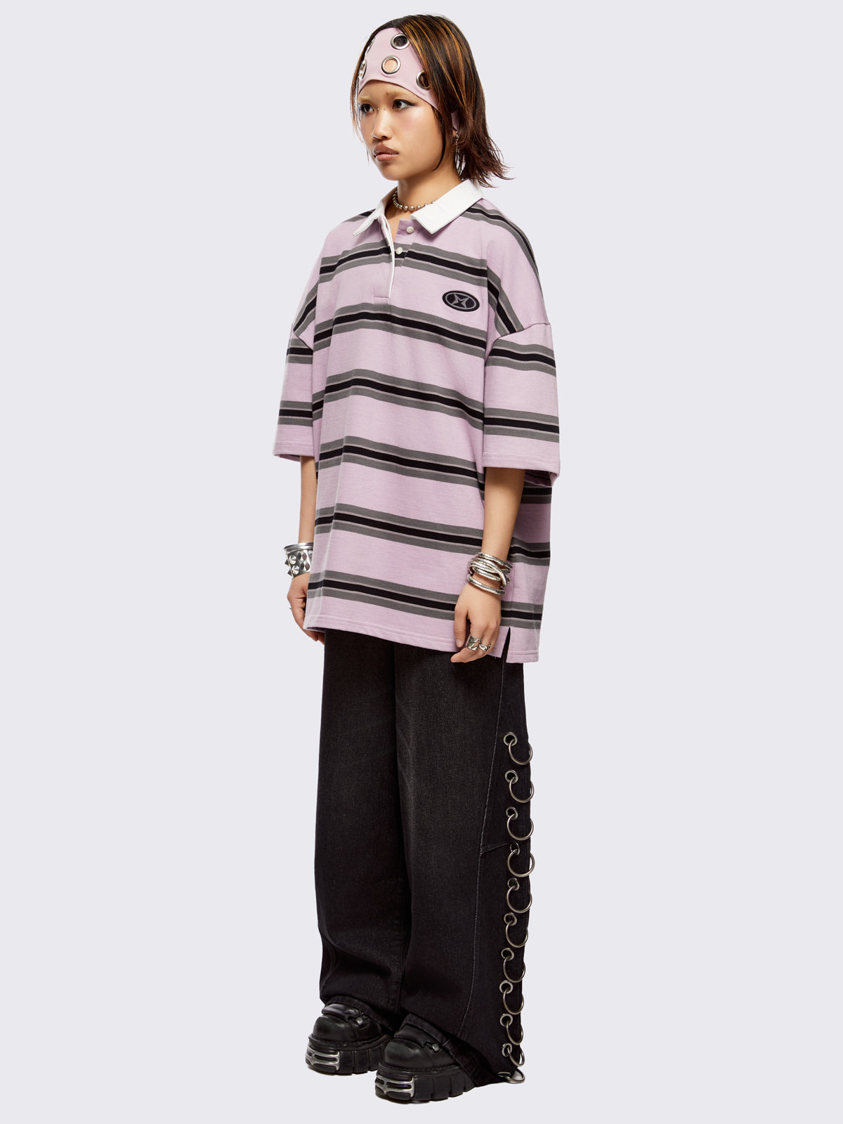 Pink rugby polo with black and grey stripes, white spread collar and a oversized fit.