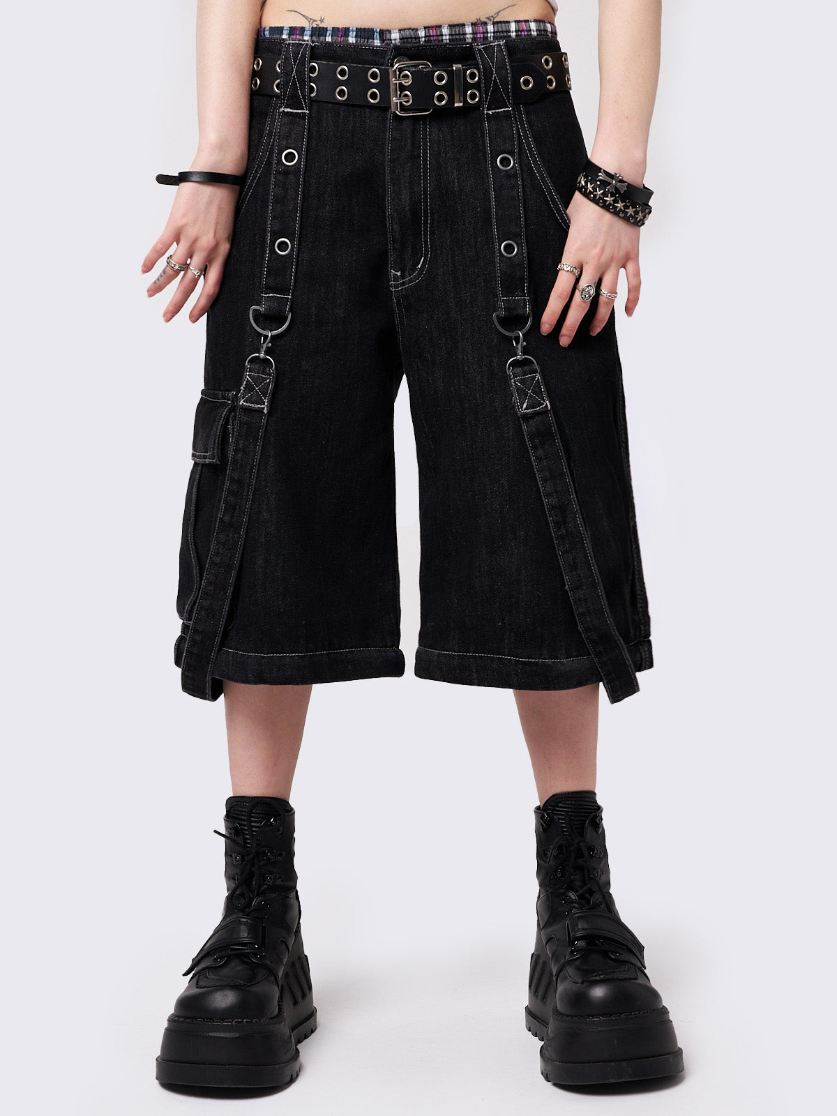 Black multi pocket cargo jeans featuring a detachable-leg with zipper and all over straps and D-rings details.