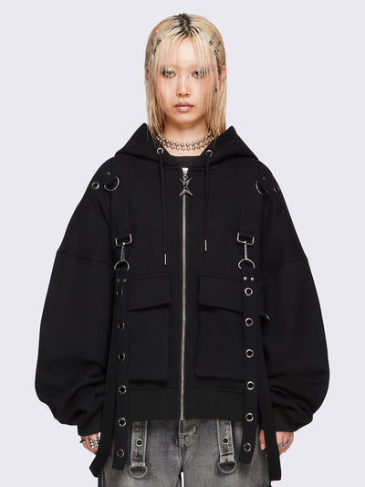 Black oversized zip-up hoodie jacket with straps, metal hardware, and flap pockets.