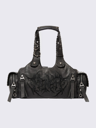 Black vegan leather shoulder bag with sigilism graphic embroidery and piercing, eyelet and stud details. 
Multiple pockets and two handles.